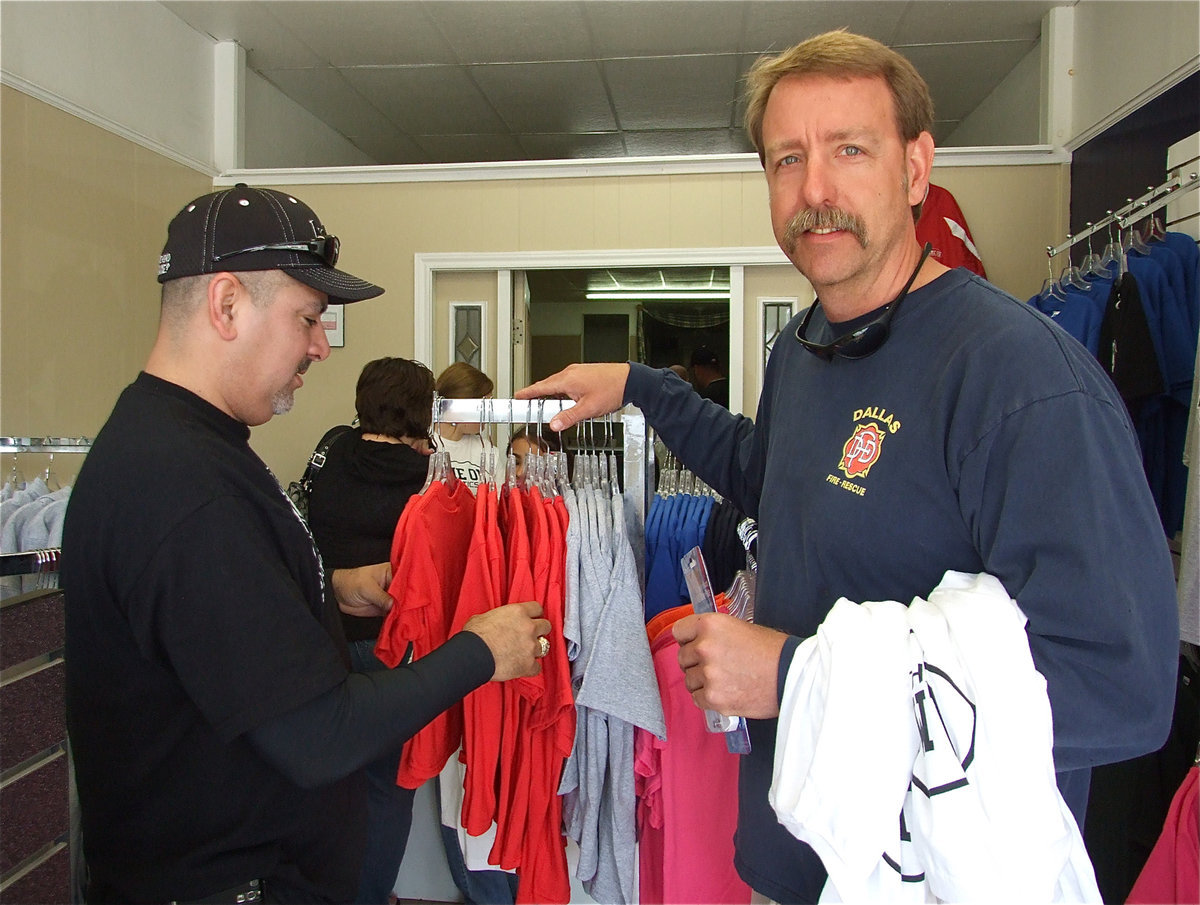 Image: Mark and Charles — Mark Jacinto and Charles Hyles wade through the wearables. Charles suggests something in a pink for Mark.