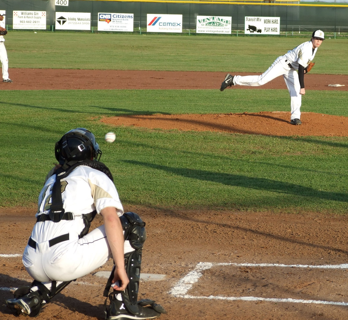 Image: Goodness gracious, great balls of fire — Pitcher, Justin Buchanan, and catcher, Ryan Ashcraft, warm up for the game against the Frost Polar Bears.