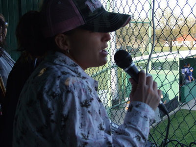 Image: “Mad Dog” Melissa — There is a lot of fun happening at the Gladiator ballgames.  Melissa Souder and Clover Stiles set up music, announcements, contests and, of course, a little bit of singing in the microphone.