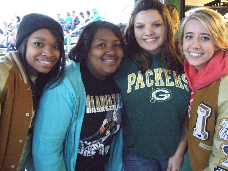 Image: All winners — Kyonne Birdsong, Ka’Deesha Davis, Cori Jeffords and Lexi Miller gather at the concession stand to help Davis show her winning coupon.  She won a free hamburger from the “Gladiator Grill” on Friday night.