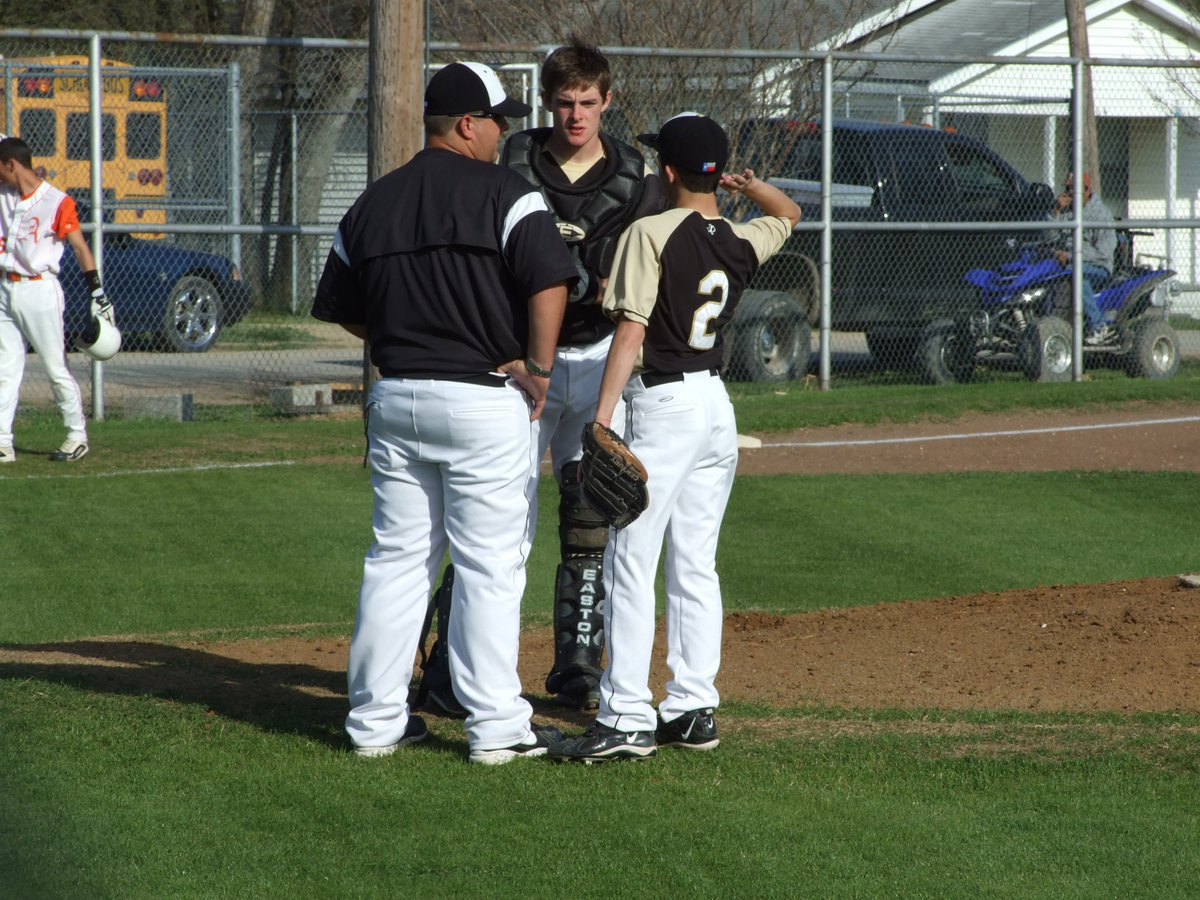 Image: Let’s talk about it — Coach Matt Coker, Ryan and Caden take a minute about the play.