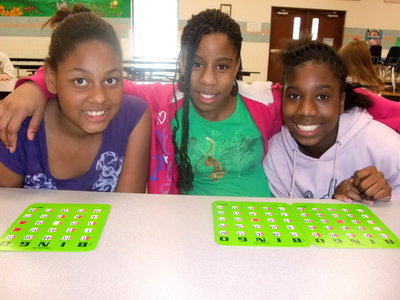 Image: Three Cute Bingo Players — Oleshia Anderson (fifth grader), Raven Harper (sixth grader) and Janae Robertson (sixth grader) were busy trying to win a prize by playing bingo.