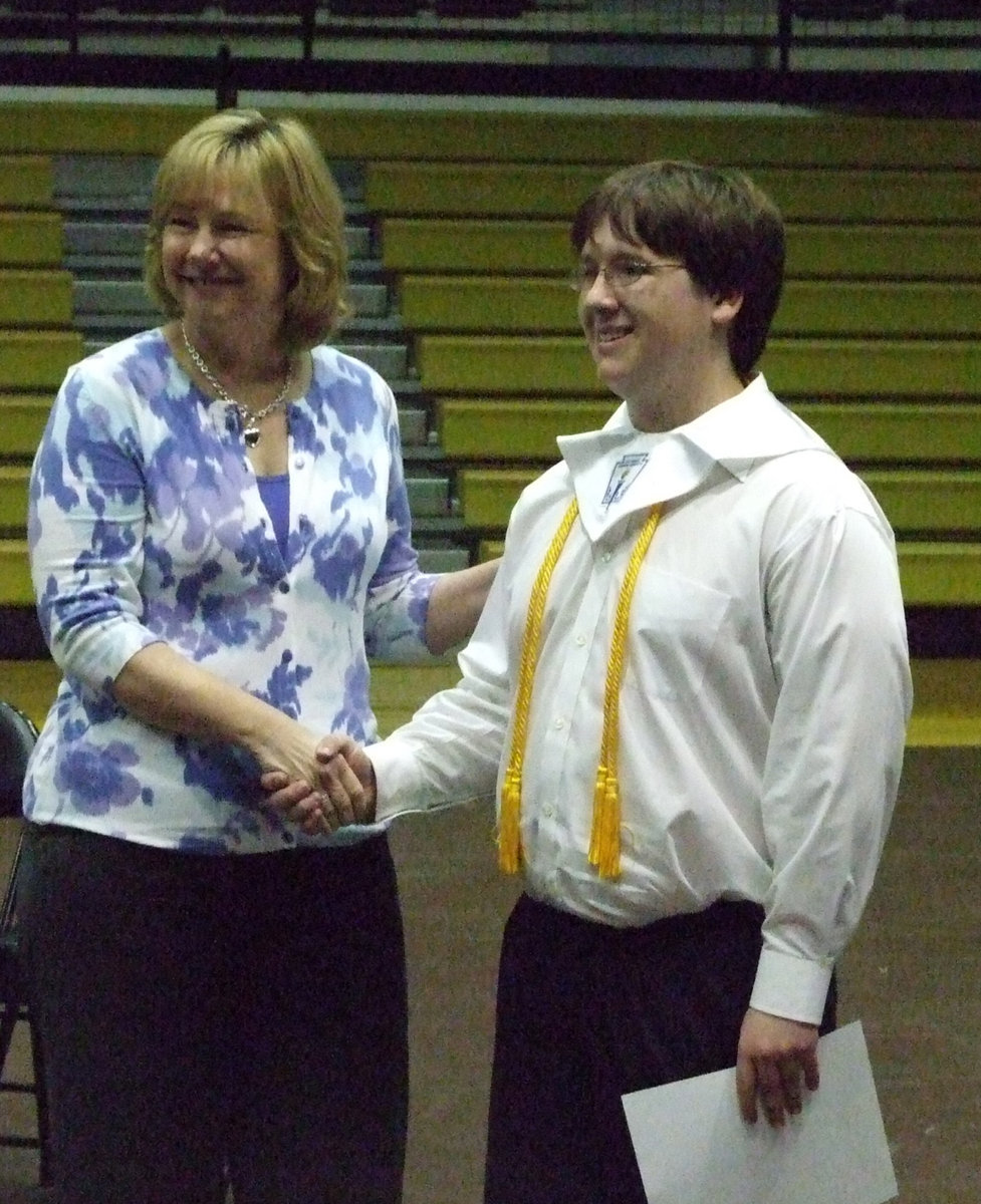 Image: George E. Scott Memorial Scholarship — Brandon Owens (pictured here) received his scholarship from Diana Herrin (daughter of George Scott) with a smile.  Other recipients included Lexi Miller, Ivan Roldan and Josh Milligan.