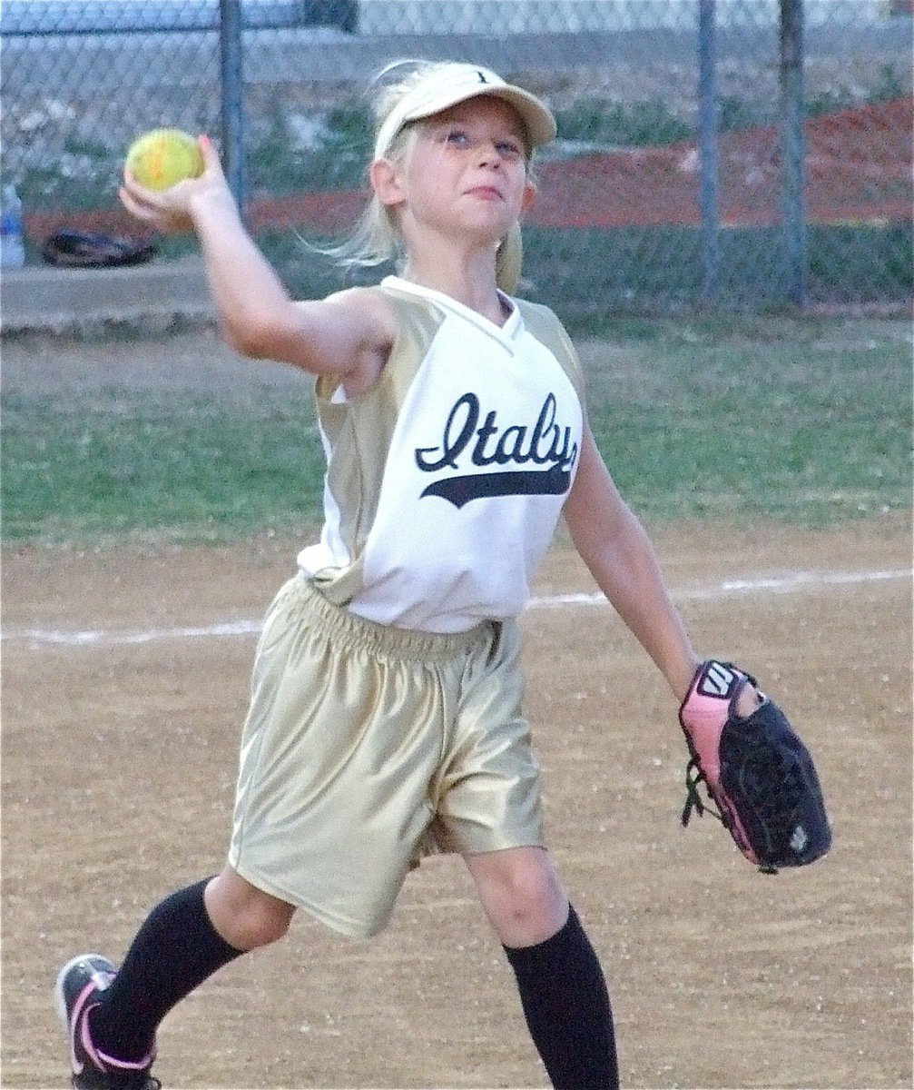 Image: Lacy hurries — Lacy Mott launches a throw to first base during the division tournament game against Whitney.