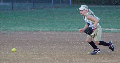 Image: Making the stop — Pitcher Lacy Mott charges a grounder.
