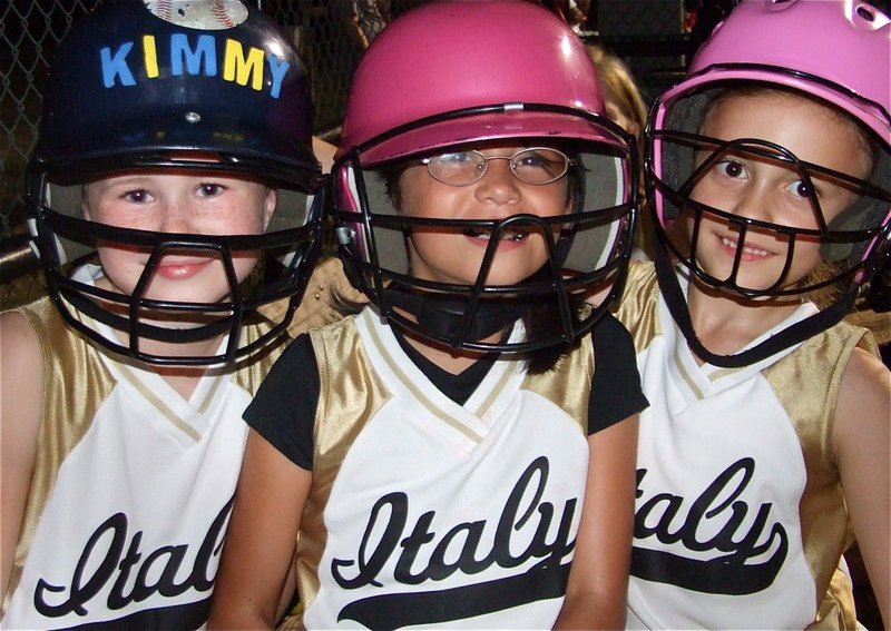 Image: Batters’ up! — Kimberly Hooker, Alexus Cisneros and Grace Payne pose for a quick picture in the dugout.