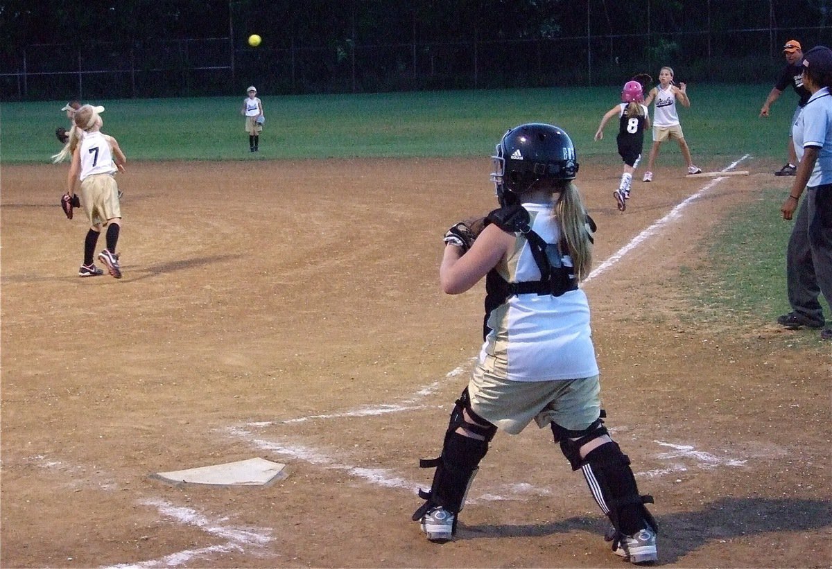 Image: Nice play! — Catcher Sydney Lowenthal covers the plate as pitcher Lacy Mott throws to first baseman Hannah Haight for the out.