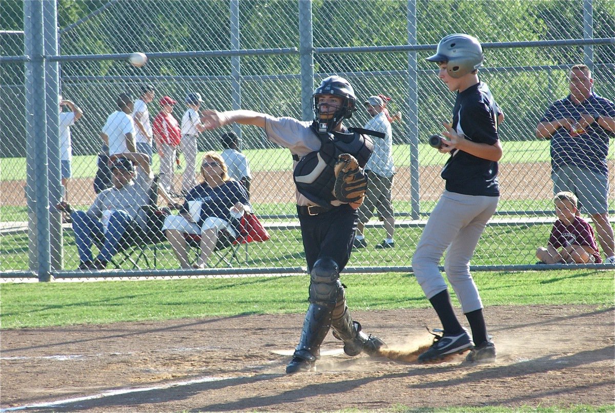 Image: Gotcha! — Justin Wood comes up firing and throws the runner out at third base before he could dive back to the bag