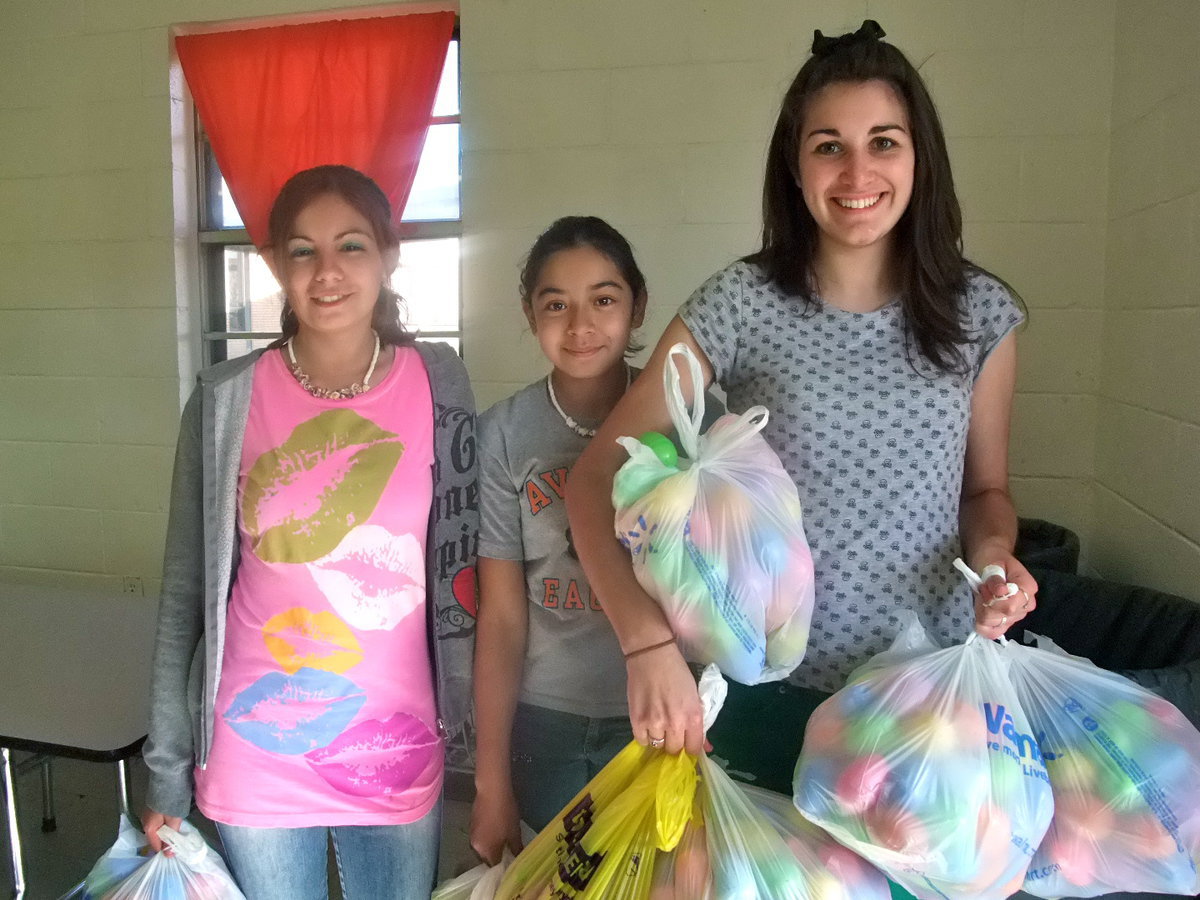 Image: Lets Hide Eggs — Selina Reyes (9th grade), Brianna Pacheco (7th grade) and Britney Dawson (Junior in high school) were ready to decorate the grounds with eggs.