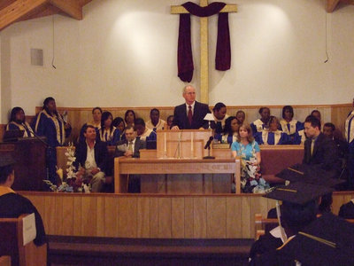 Image: Rev. Ronnie Dabney — Pastor of the First Baptist Church, Ronnie Dabney, gives the benediction and blessing before releasing the students.