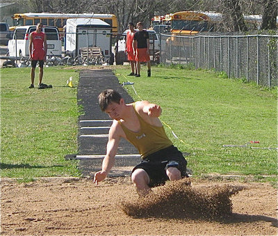 Image: Sand surfing — Just a day at the beach for Chase Hamilton at the triple jump.