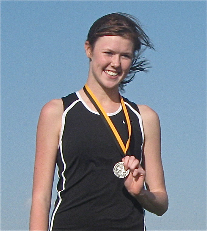 Image: Kaitlyn Rossa — Rossa shows off her medal while proudly standing atop the winner’s podium.