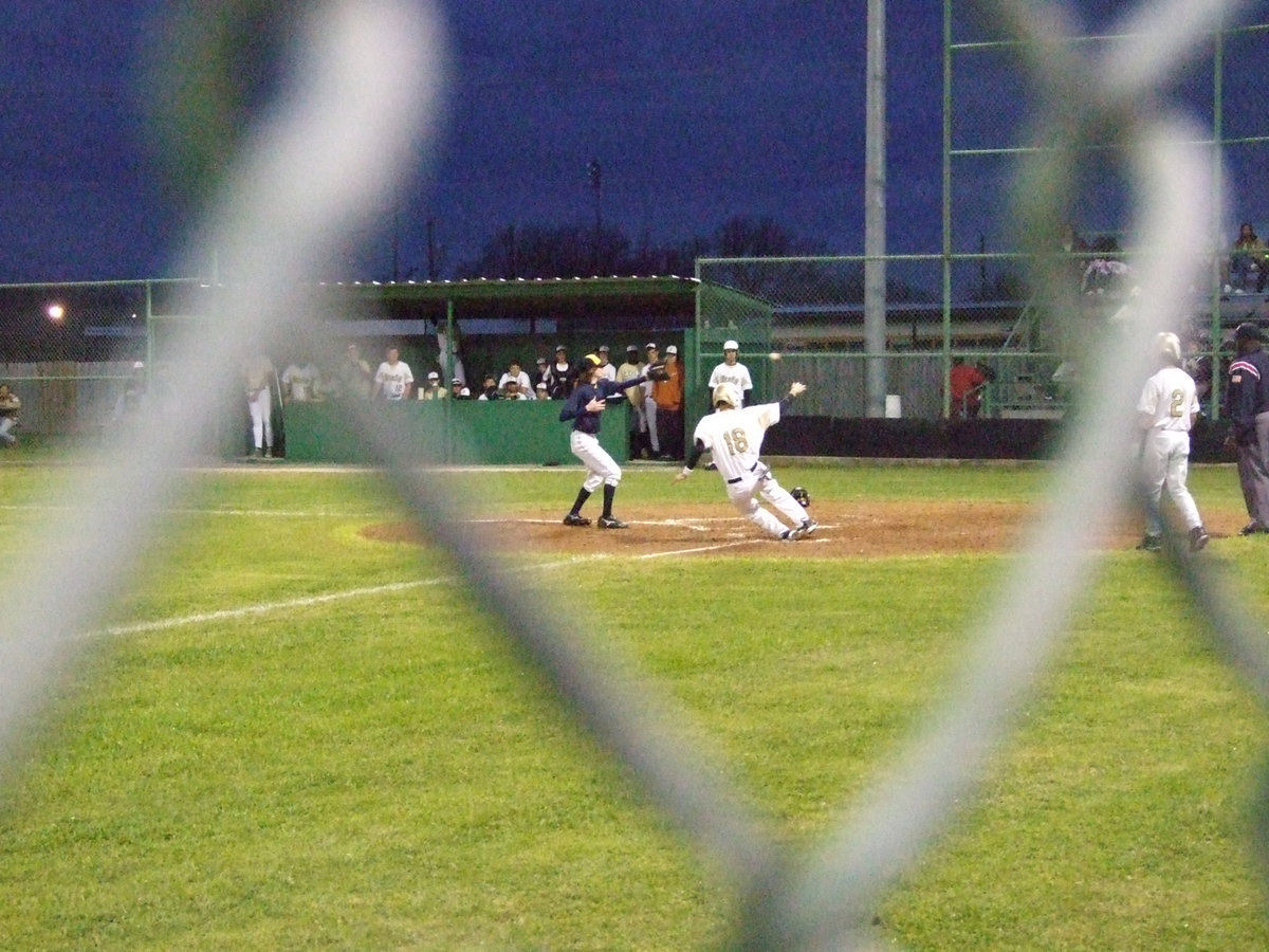 Image: Oscar is in rare form — Oscar Gonzalez slides for another score on the board.