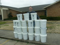 Image: Central Baptist Church aids Haiti relief — Pastor Todd Gray of Central Baptist Church in Italy with the 21 buckets his members donated to the Haiti relief effort.