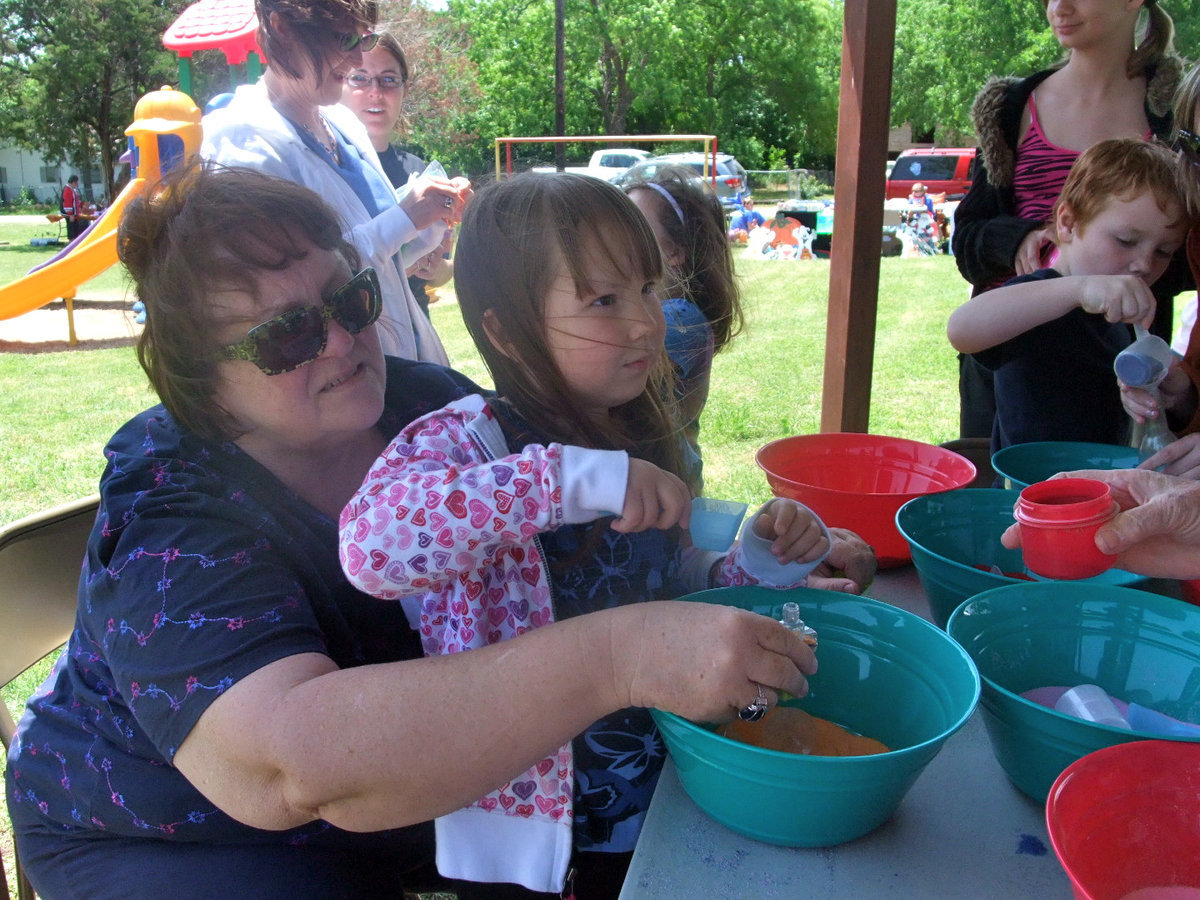 Image: Titus Women’s Crafts for Kids — This is a booth by the Titus women and they had arts and crafts for the children. The children were making sand art, coloring frisbees and place mats.