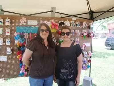 Image: Cookie Hoffman and Melanie Smith — “We are with Happy Goose from Forney. We are here today trying to sell our hand made products. Have been in business for 2 years selling bows and hair accessories.”