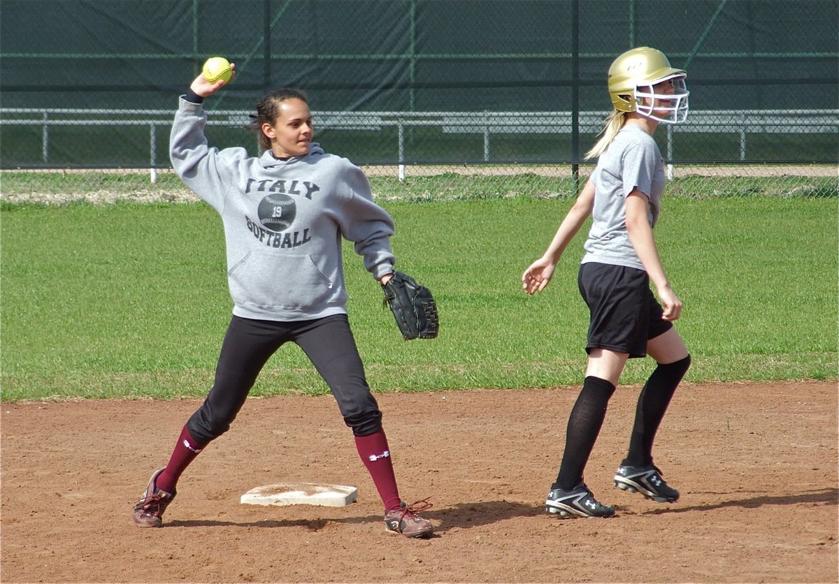 Image: Base work — Anna Viers returns the ball to the pitcher’s mound after a play at 2nd base with teammate Sierra Harris.