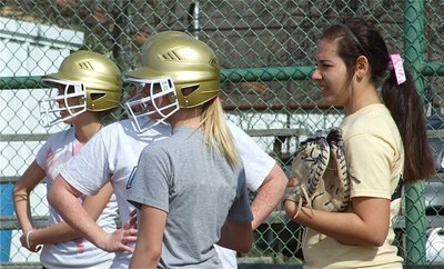 Image: Watching coach — Paola Mata, Katie Byers, Sierra Harris and Alyssa Richards listen to Coach Reeves explain proper bunting techniques.