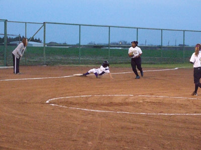 Image: Everman slides to 3rd — A Lady Bulldog takes a chance in front of sophomore Sa’Kendra Norwood.