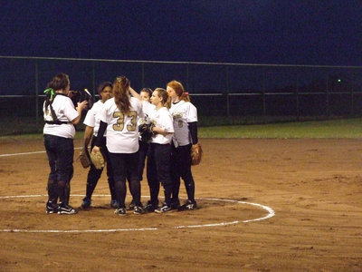 Image: Circle up — Lady Gladiator infield comes in for one more talk.
