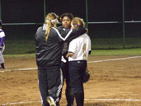Image: Reeves and her team — Coach Reeves tells pitcher and catcher her new strategy.