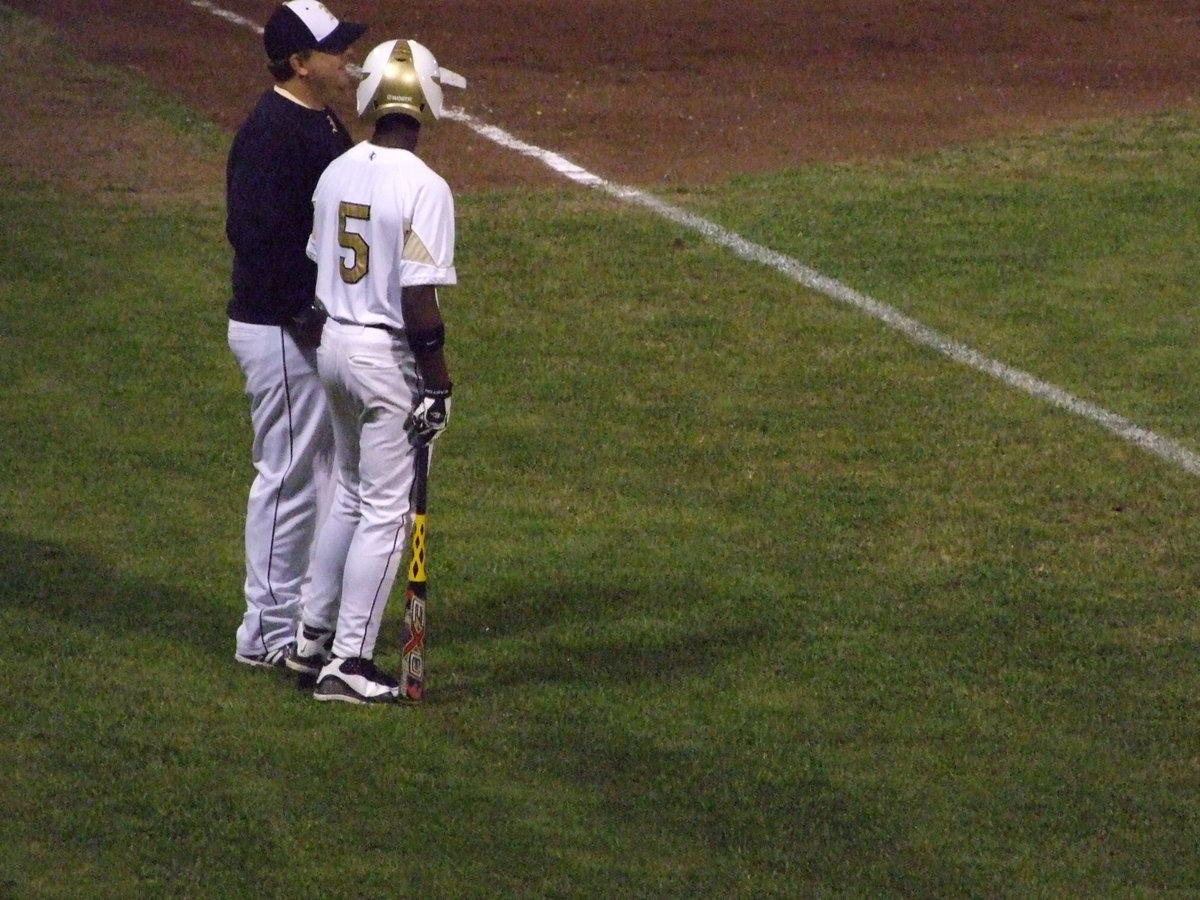 Image: Marvin gets the strategy — Coach Coker speaks to Marvin Cox about the upcoming play.