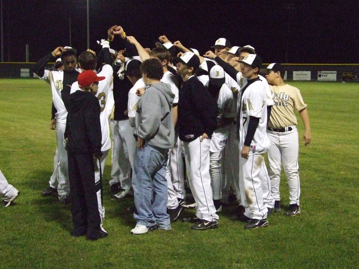 Image: Huddle up — Coach Coker and Ward give the aftergame talk.