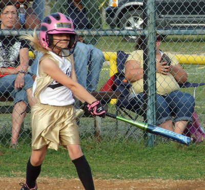 Image: Lacy hits on — Lacy Mott hits a single for the 8u girls softball team which is head coached by her mom, Lisa Mott.