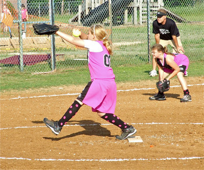 Image: Brycelen pitches — The 10u girls softball team, famously known as the Pink Panthers, are undefeated as Brycelyn Richards delivers another strike and third baseman Carlee Wafer stays ready to attack.