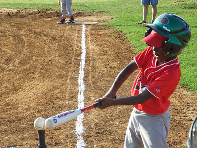 Image: Julius lines it up — Julius Wilson lines up the bat and then hit a liner to the outfield in the T-Ball boys game on Monday.