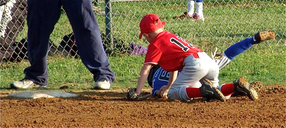 Image: How it’s done — Italy’s Ty Cash gets the out at third base, leaving no doubt.