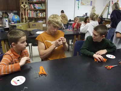 Image: They Are Wired — Trevor Kern (4th grade), Jeremy Knight (senior) and Luke Tennery (4th grade) are busy wiring their Jitterbugs.