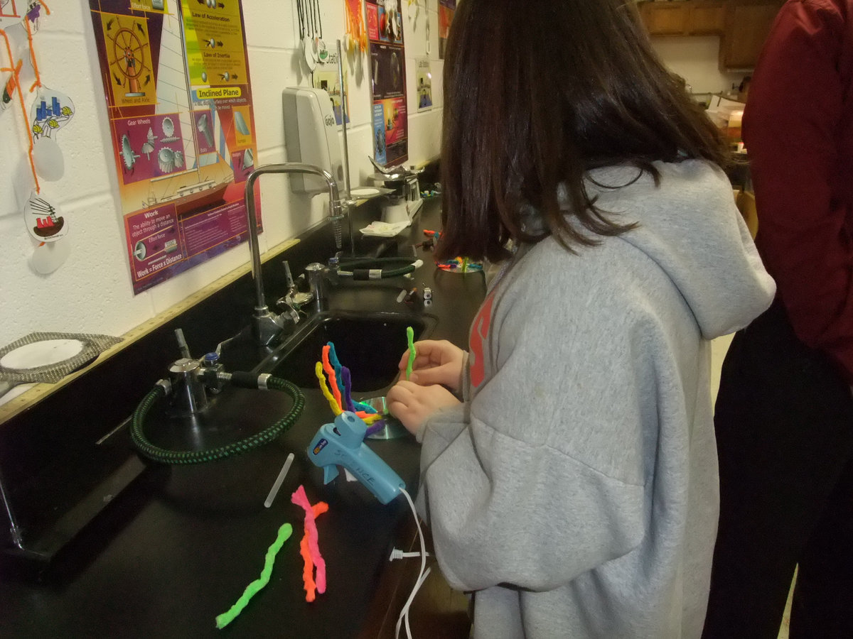 Image: Busy Glueing The Legs — This student is busy glueing on legs for the Jitterbug.