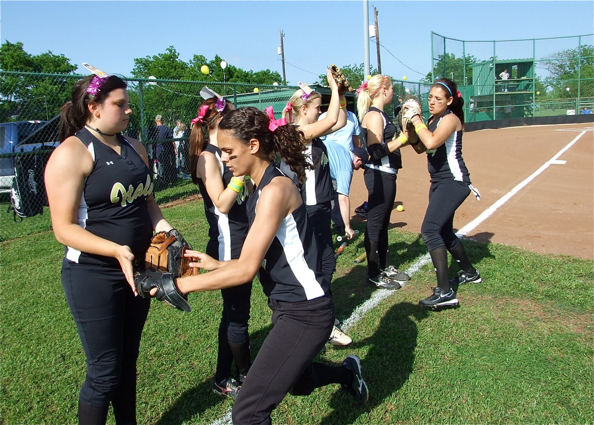 Image: Glove taps — Cori Jeffords, Drew Windham, Courtney Westbrook and Megan Richards get glove taps from their infield teammates, Anna Viers and Alyssa Richards.