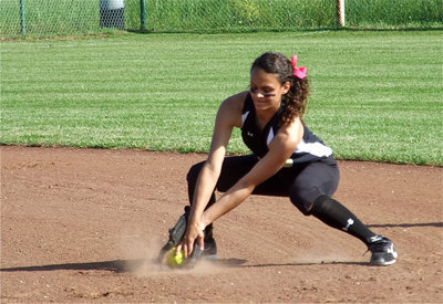 Image: Anna is athletic — Shortstop Anna Viers digs a grounder out of the sand.