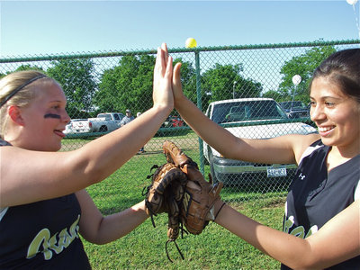 Image: Powers activated! — Drenda Burk and Alma Suaste demonstrate their unique high-five.