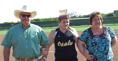 Image: We love this girl — Graduating senior Meredith Brummett stands with her parents, Donald and Karen, during her introduction on Senior Day.