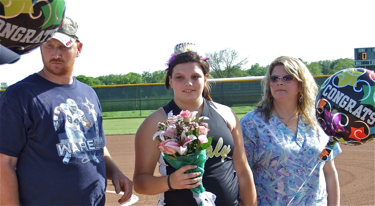 Image: Here for Cori — Graduating senior Cori jeffords is escorted by her parents, John and Mikki, during her introduction on Senior Day. As if she needed an introduction.