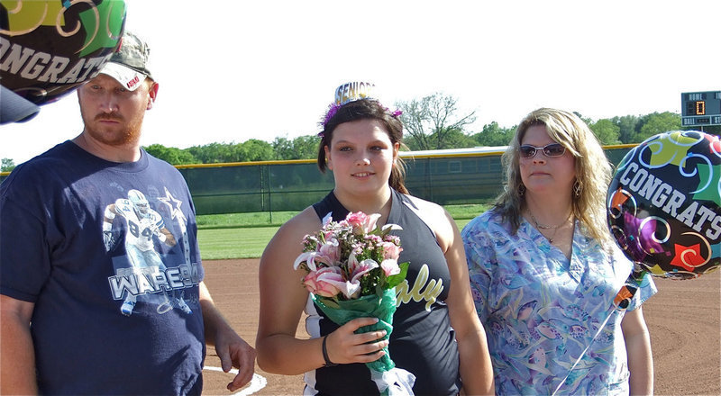 Image: Here for Cori — Graduating senior Cori jeffords is escorted by her parents, John and Mikki, during her introduction on Senior Day. As if she needed an introduction.