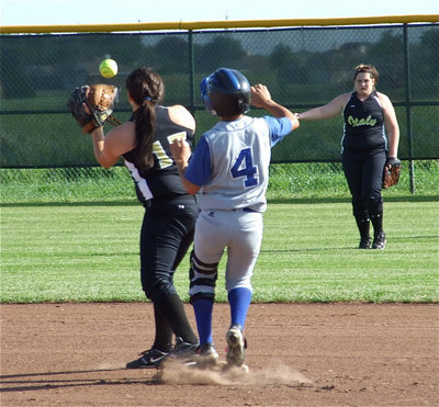 Image: Seniors connect — Left fielder Meredith Brummett fires the ball into second baseman Cori Jeffords to hold the Frost runner on base.