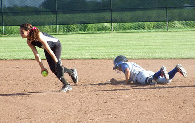Image: Viers wins crash — Shortstop Anna Viers hops up after getting the Frost runner out at second base.