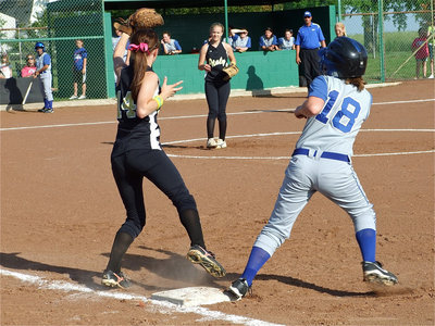 Image: Play at first — Lady Gladiator first baseman Drew Windham catches a pass from catcher Alyssa Richards in an attempt to sneak up on a Lady Polar Bear.