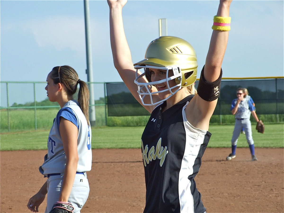 Image: Touchdown! — The Lady Gladiators lead 7-0 midway thru the game against Frost as Courtney Westbrook celebrates hitting a single.