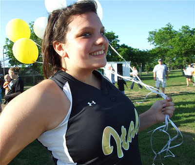 Image: Cori’s smiling — Cori “No Guts, No Glory” Jeffords, a graduating senior, has fun after the game on Senior Night collecting balloons full of memories.