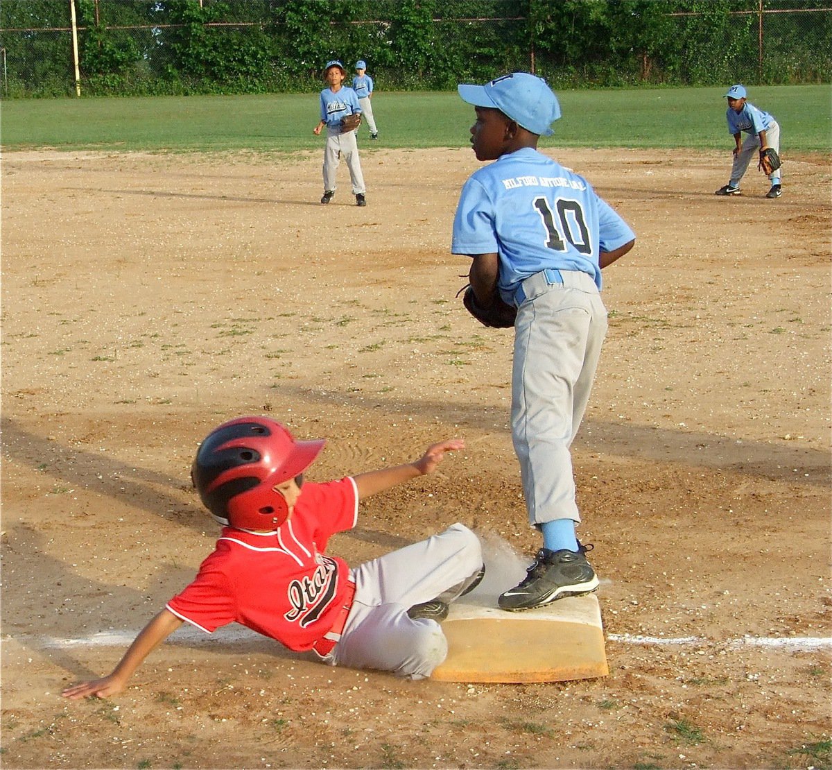 Image: Christian can play — Milford’s Christian Cole makes the catch for an out at first base against Italy.