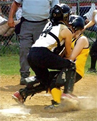 Image: Tate protects plate — IYAA 15u girl’s softball catcher, Mary Tate, makes a stand at the plate and gets a  much needed out against Itasca.