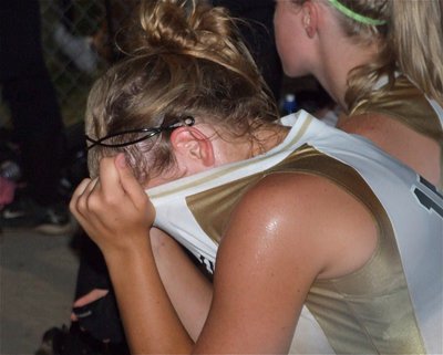 Image: A towel would be nice — 7th grade pitcher, Jaclynn Lewis, pours her heart into every pitch and takes a moment to cool off in the dugout.