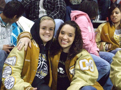 Image: Best Friends — Courtney Westbrook and Kelli Strickland cuddle for warmth during the Gladiator game.