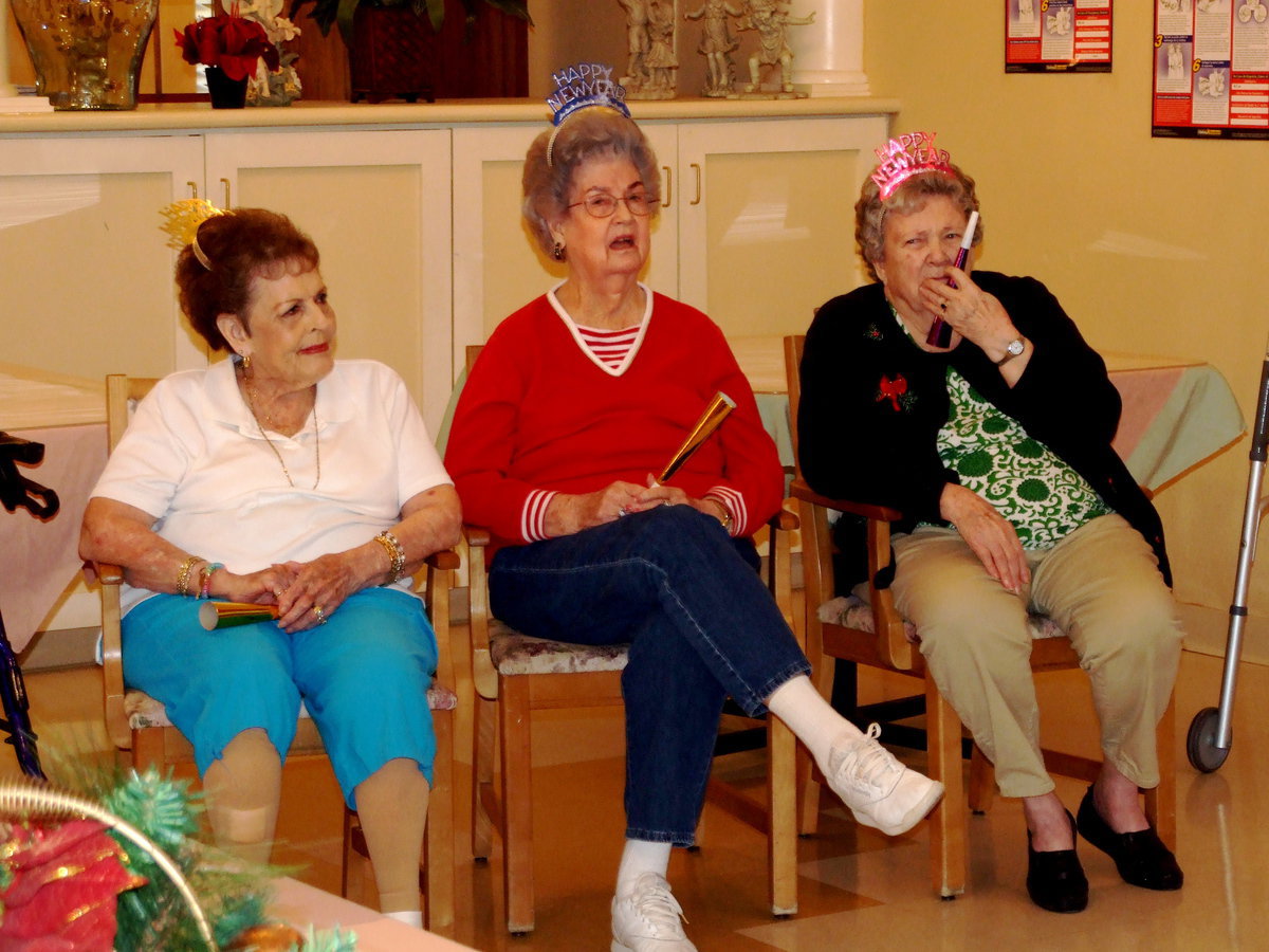 Image: Party Hats and Horns — Residents listening intently.