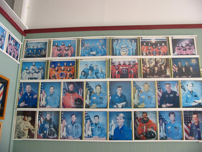Image: Autographs — Autographed color pictures of astronauts line the walls of Jeff’s Barber Shop.